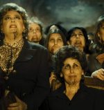 the witches from Witching and Bitching gather in the cave